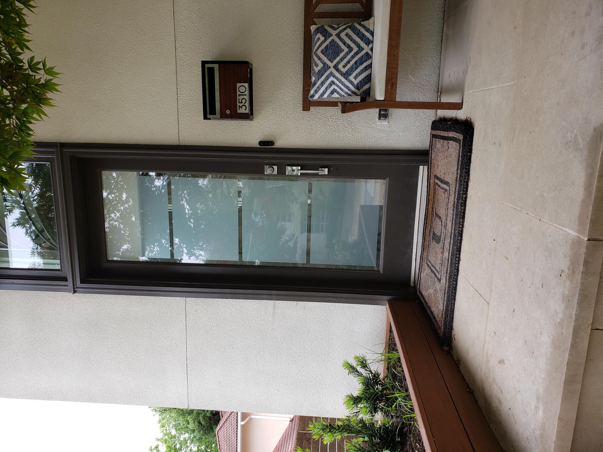 Residential entry door with decorative frosted stripe film