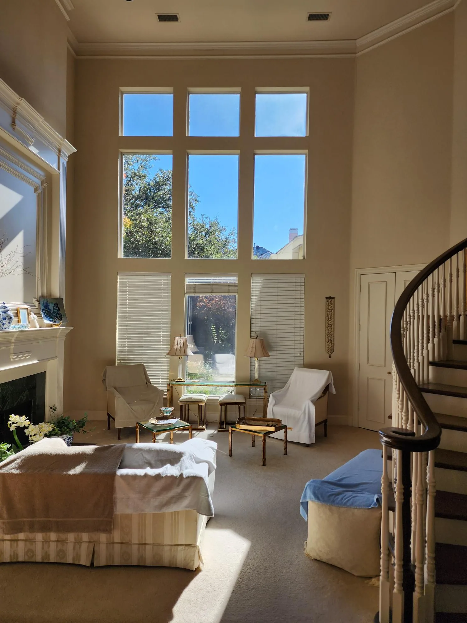 Large cream stucco home terra cotta roof dark tinted windows DFW