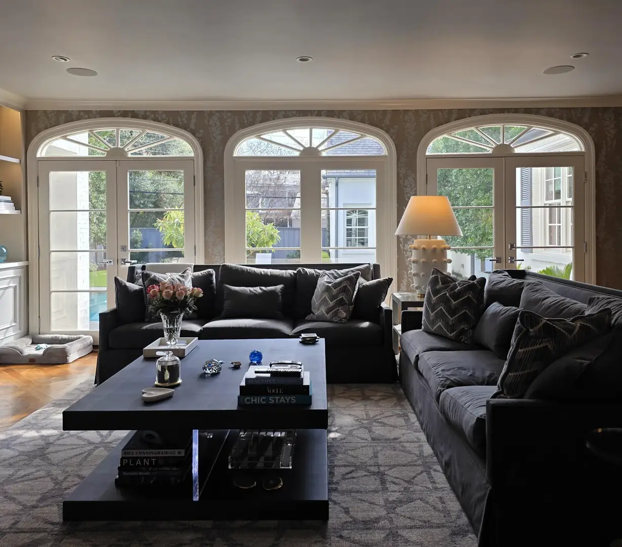 Elegant living room three arched French doors pool view solar film DFW